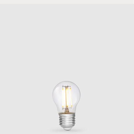 Dulora 4W 12-24 Volt AC/DC Fancy Round LED Bulb E27 in Warm White illuminated with warm light through clear round glass