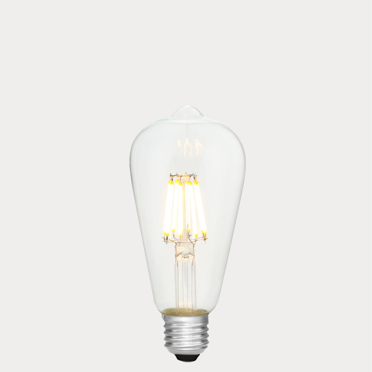 Dulora 8W E27 LED Edison-style bulb in clear glass with AC/DC compatibility, glowing with 2700K warm white light.